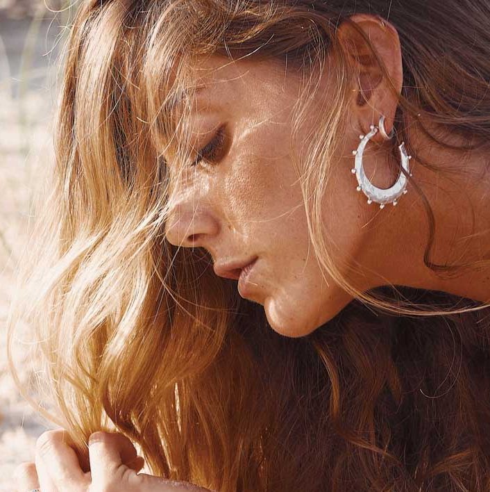 earrings beach ocean themed jewellery worn by girl on the sand