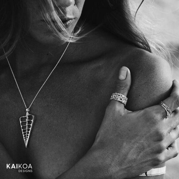 woman wearing ocean inspired handmade cerithium shell pendant made in Australia in sterling silver on bare skin