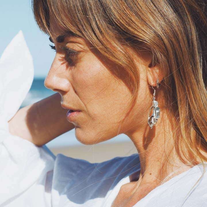 Blonde woman wearing ocean beach inspired silver jewellery that is made in Australia