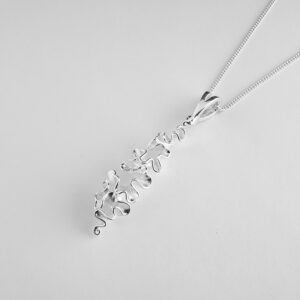 Silver pendant resembling seaweed design