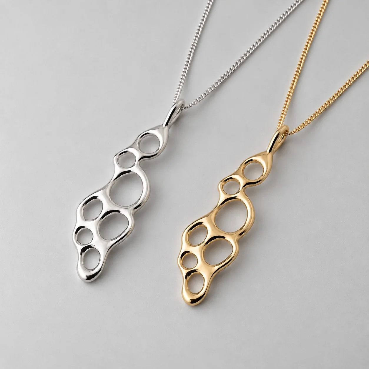 Tidal Swell pendants in sterling silver and solid gold